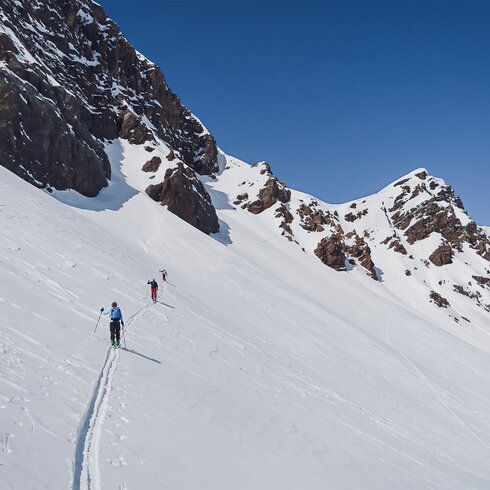 Drei Skitourengänger sind hintereinander auf der gleichen Spur unterwegs. | © Davos Klosters Mountains