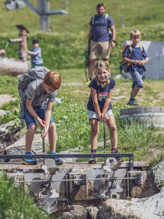 Children playing with a water lock at Madrisa-Land.  | © Davos Klosters Mountains