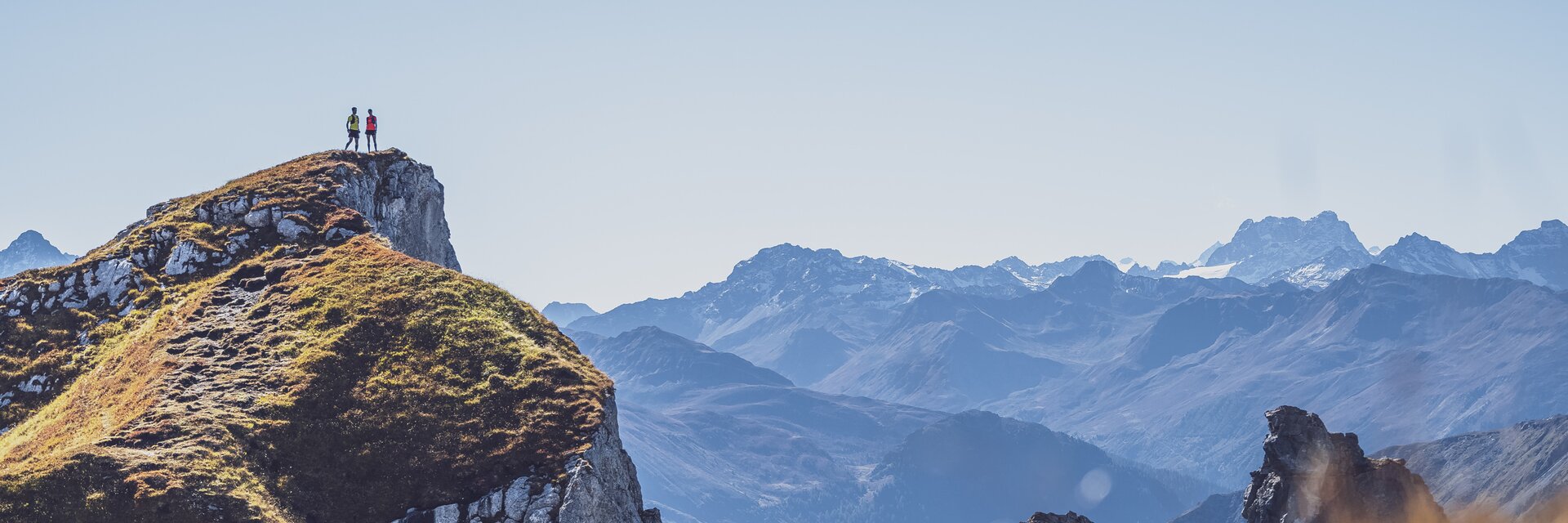 Zwei Trailrunner stehen auf dem Geisshorn und geniessen das wunderschöne Panorama.  | © Davos Klosters Mountains