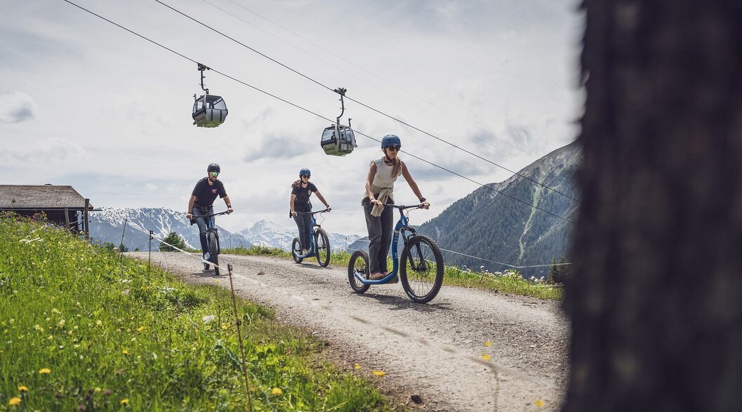 Trottinettfaher unterhalb der Gondelbahn am Rinerhorn in Davos. | © Davos Klosters Mountains